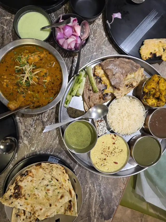 Himalayan homestay meal with local fruit, bread, and honey on a wooden table